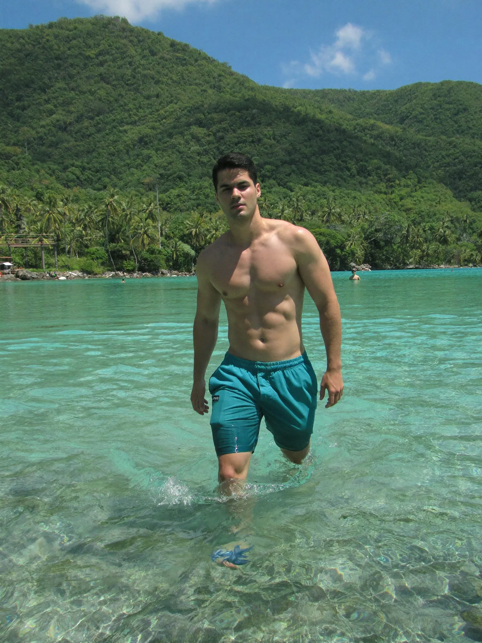 IceZone — teal swim shorts in a clear turquoise lagoon