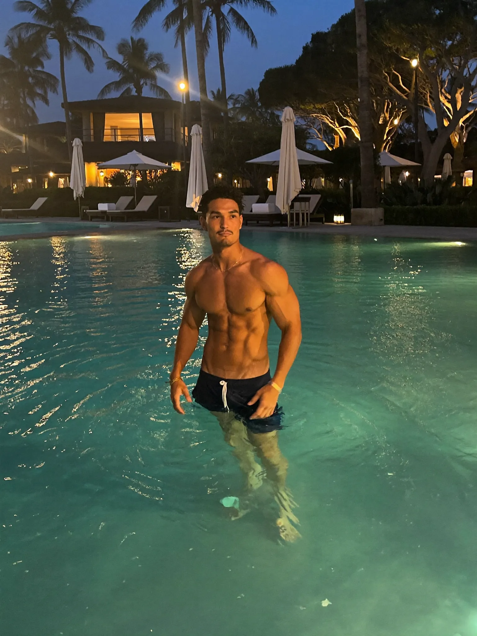 IceZone — navy swim shorts beside a glowing pool at night